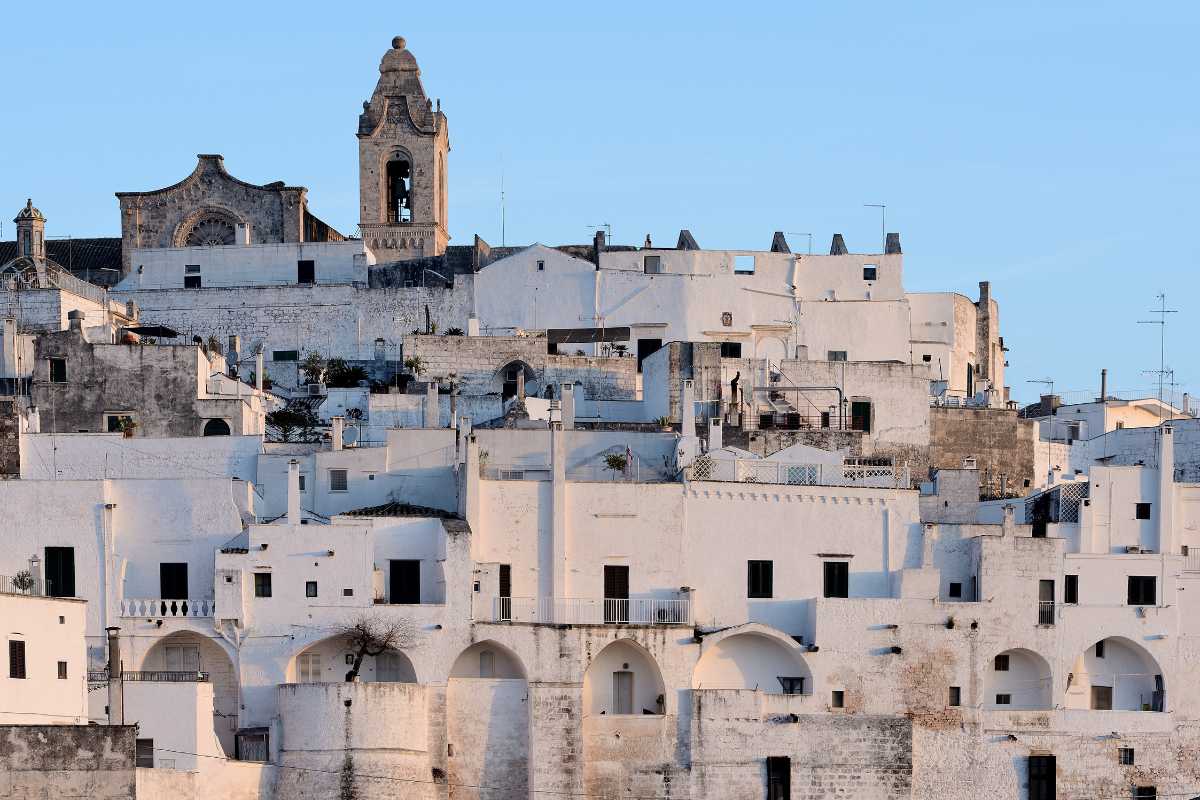 Un'immagine di Ostuni con i suoi vicoli bianchi e il mare sullo sfondo