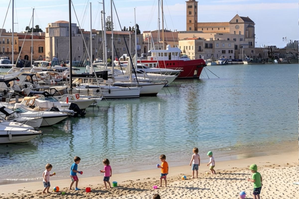 Vista panoramica del porto di Trani con bambini che giocano sulla spiaggia